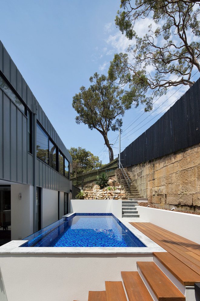 Large trendy three-story flat roof photo in Sydney