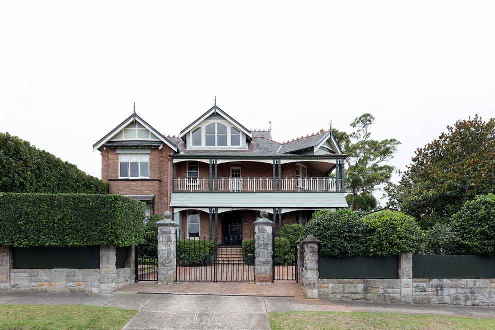 This is an example of an expansive victorian detached house in Sydney with three floors and a shingle roof.
