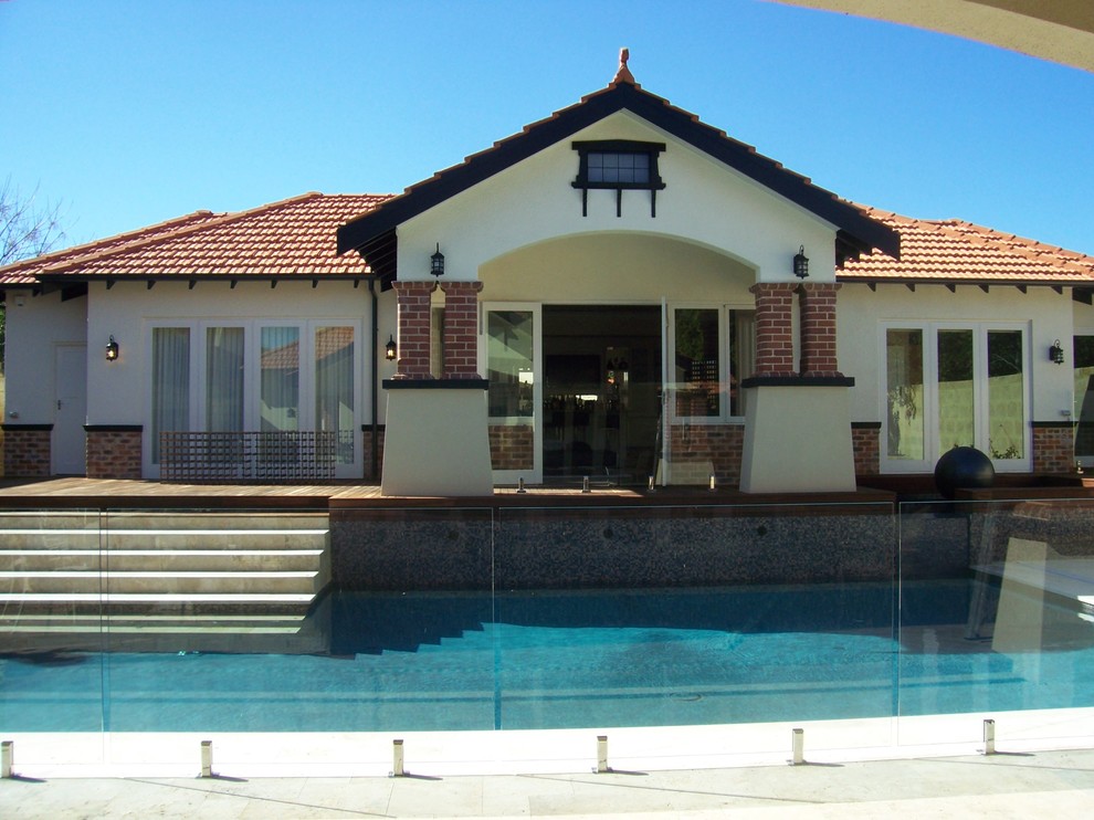 This is an example of a large and brown modern bungalow brick detached house in Perth with a pitched roof and a shingle roof.