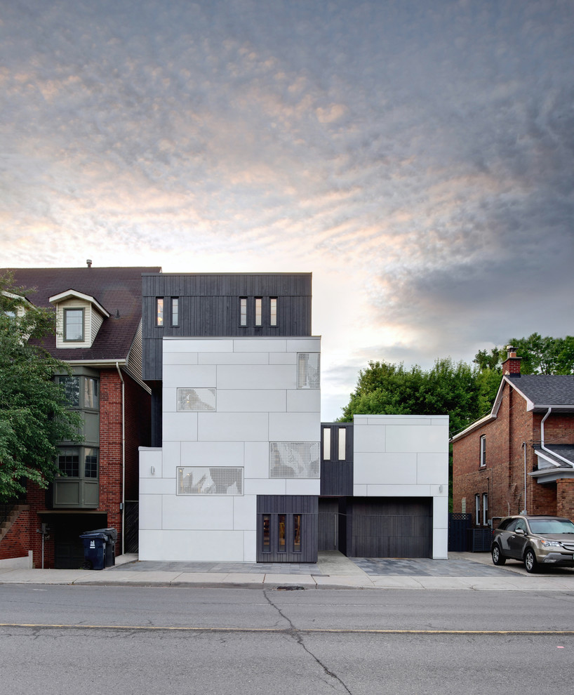 Large danish white three-story concrete fiberboard exterior home photo in Toronto
