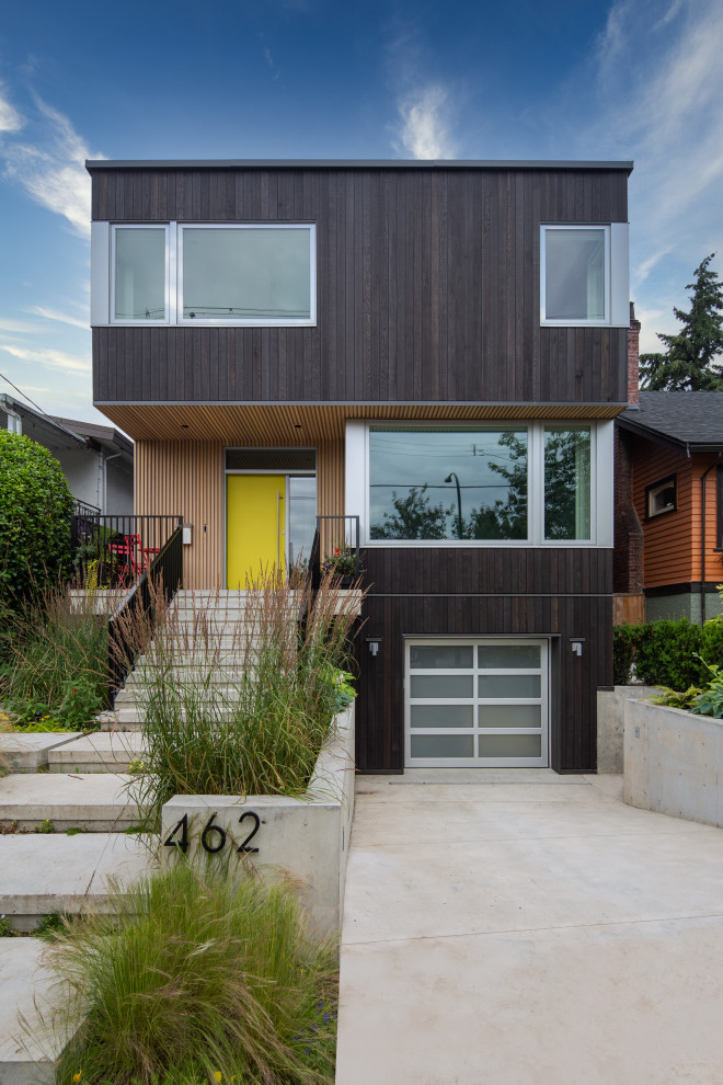 Example of a trendy brown two-story wood house exterior design in Vancouver