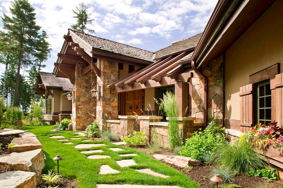 This is an example of an expansive and beige rustic two floor detached house in Denver with a pitched roof, a mixed material roof and mixed cladding.