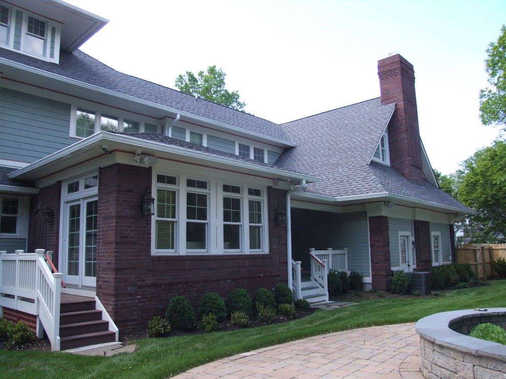 Inspiration for a large craftsman green three-story brick exterior home remodel in Newark with a hip roof
