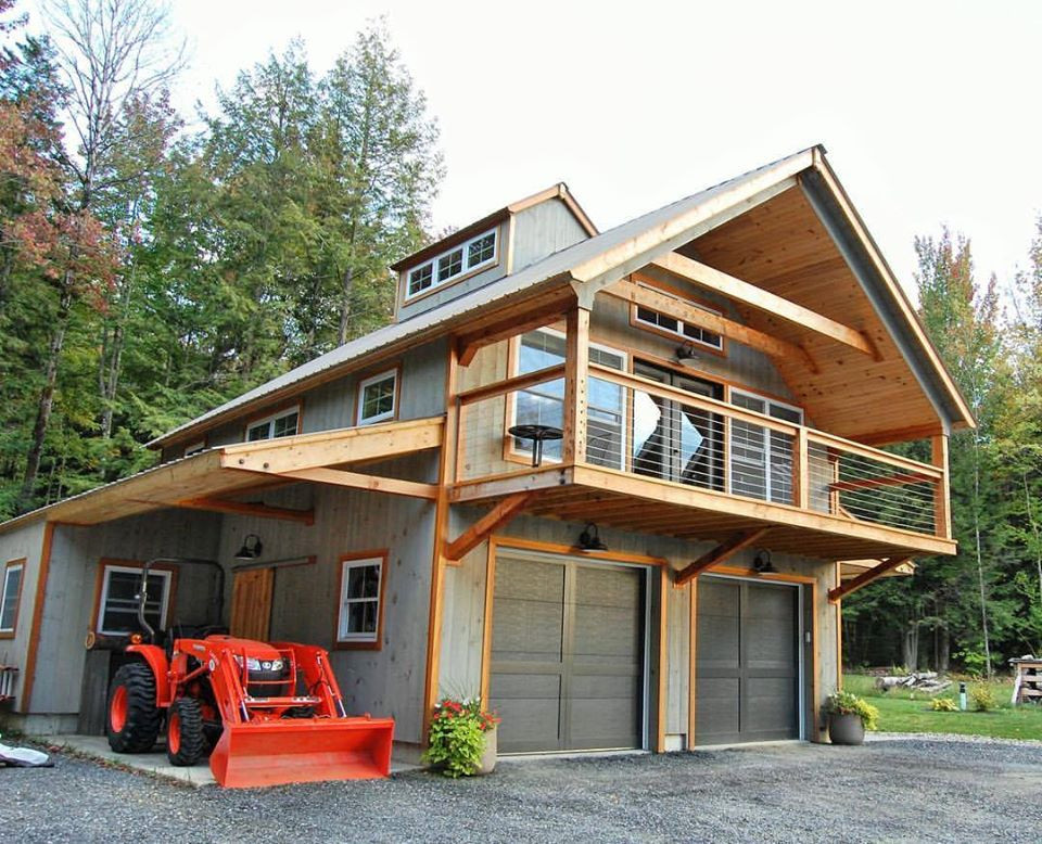 Inspiration for a mid-sized farmhouse gray two-story wood apartment exterior remodel in Burlington with a metal roof