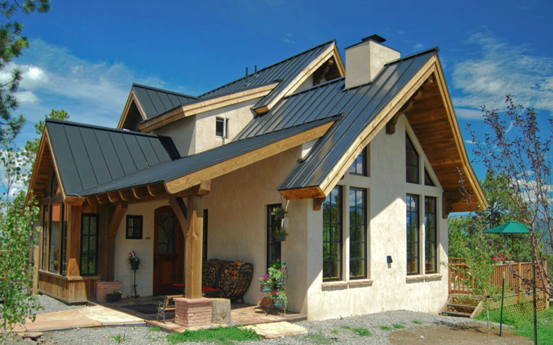 Inspiration for a mid-sized timeless white one-story mixed siding house exterior remodel in Denver with a metal roof