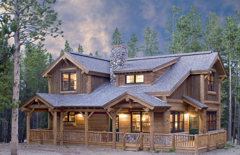 This is an example of a medium sized rustic two floor house exterior in Denver with wood cladding.