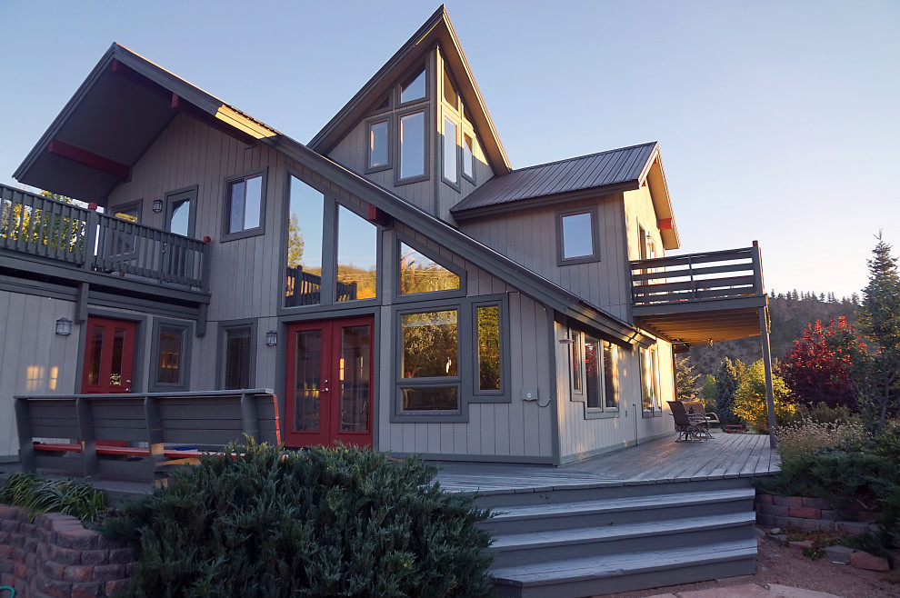 Inspiration pour une façade de maison grise design avec un toit en métal.