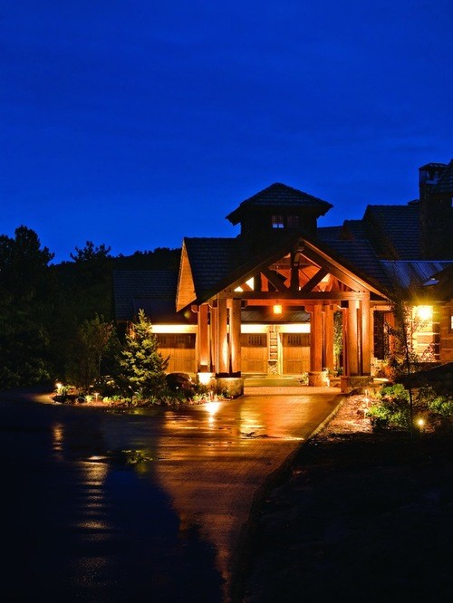 Example of a large mountain style wood gable roof design in Denver