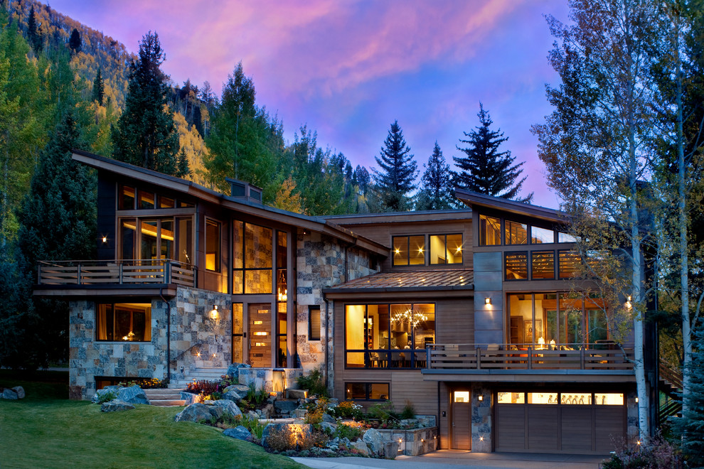 Large rustic three-story mixed siding exterior home idea in Denver with a shed roof