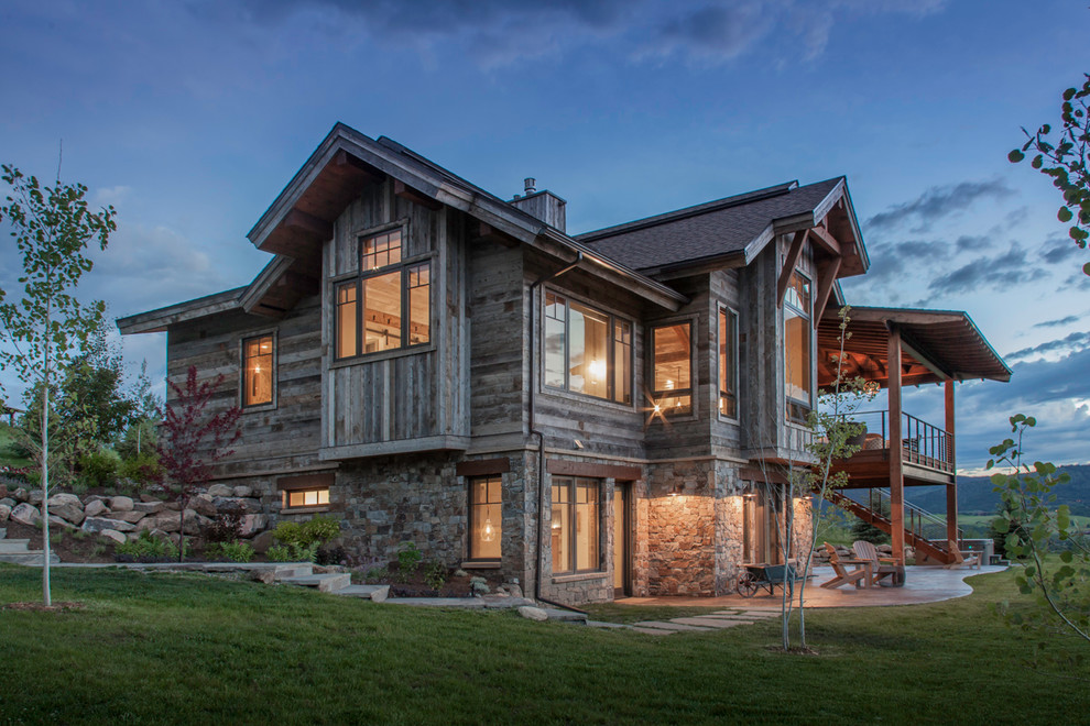 Rustic two floor house exterior in Denver with wood cladding and a pitched roof.