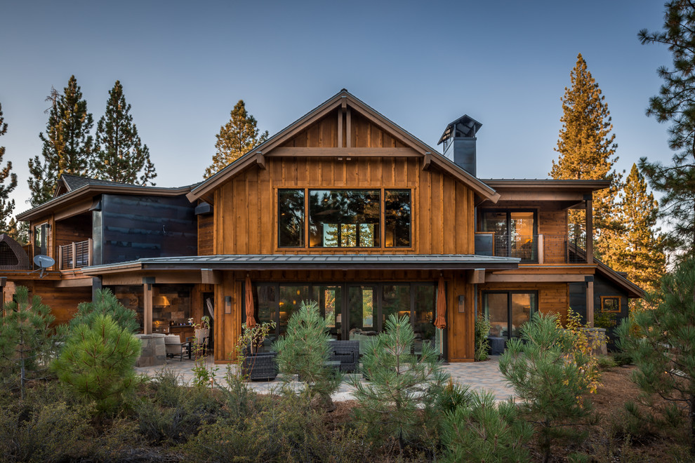 Example of a large mountain style brown two-story wood exterior home design in Sacramento with a mixed material roof