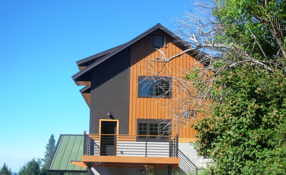 Mid-sized traditional beige two-story wood house exterior idea in Seattle with a shed roof and a metal roof