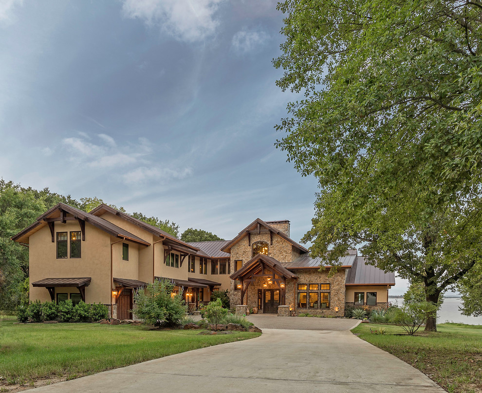 Large mountain style brown two-story mixed siding exterior home photo in Dallas with a metal roof