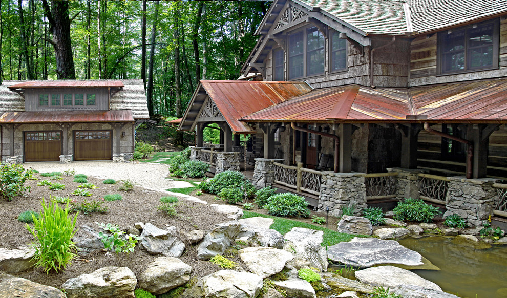 Inspiration for a rustic two-story exterior home remodel in Other with a mixed material roof