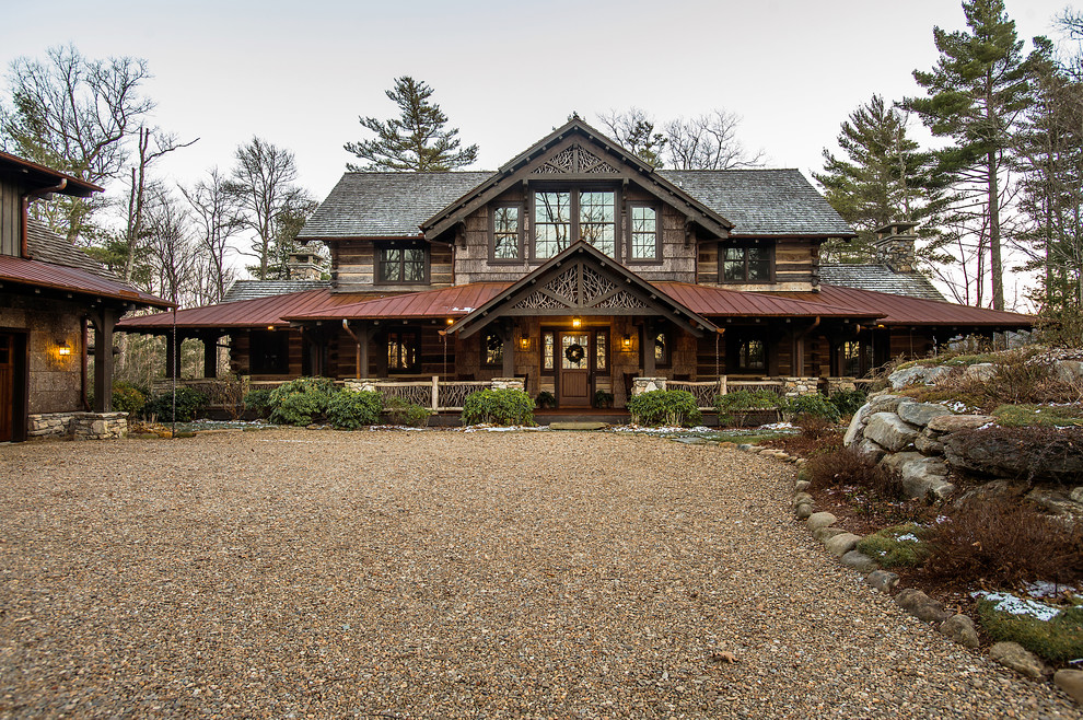 Mid-sized mountain style brown two-story wood exterior home photo in Other