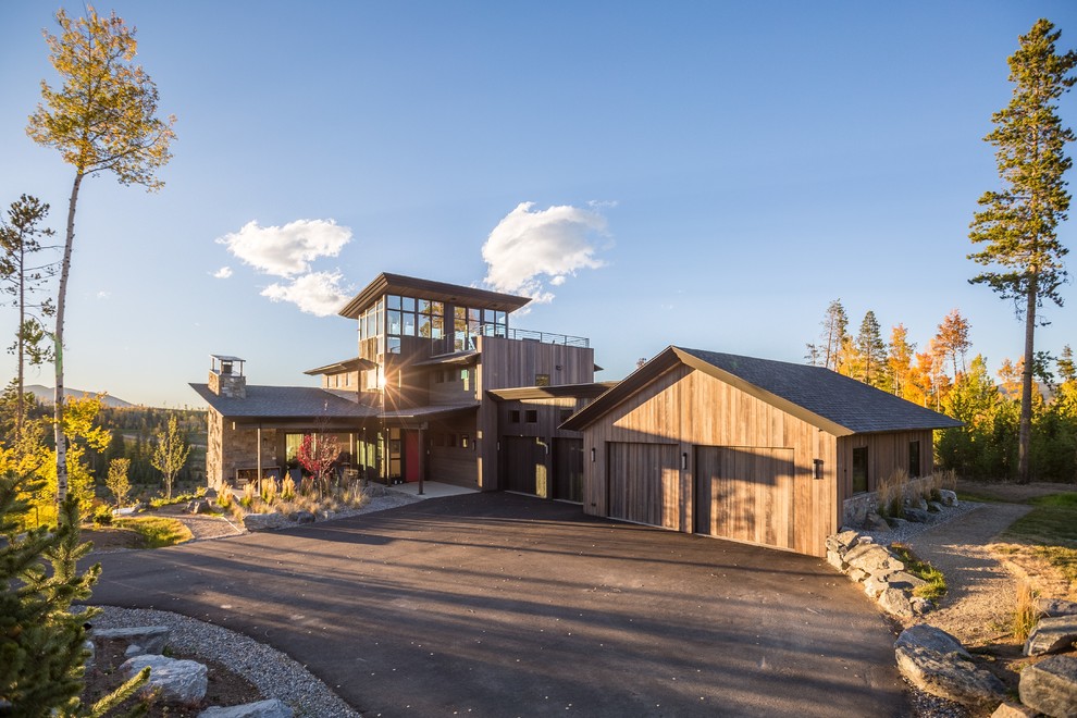 This is an example of a large and brown rustic two floor detached house in Denver with wood cladding, a hip roof and a shingle roof.