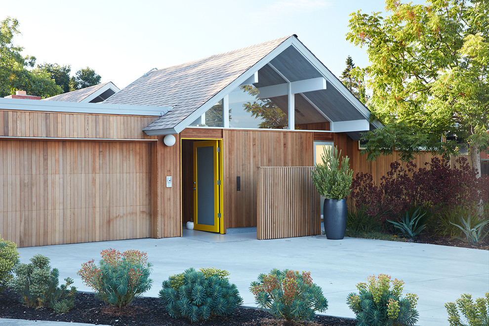 Foto della facciata di una casa moderna con rivestimento in legno e tetto a capanna