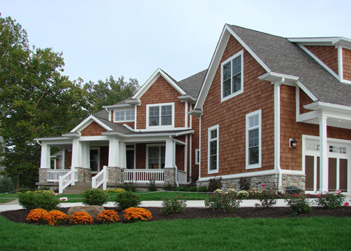 Foto della facciata di una casa marrone classica a due piani di medie dimensioni con rivestimento in legno