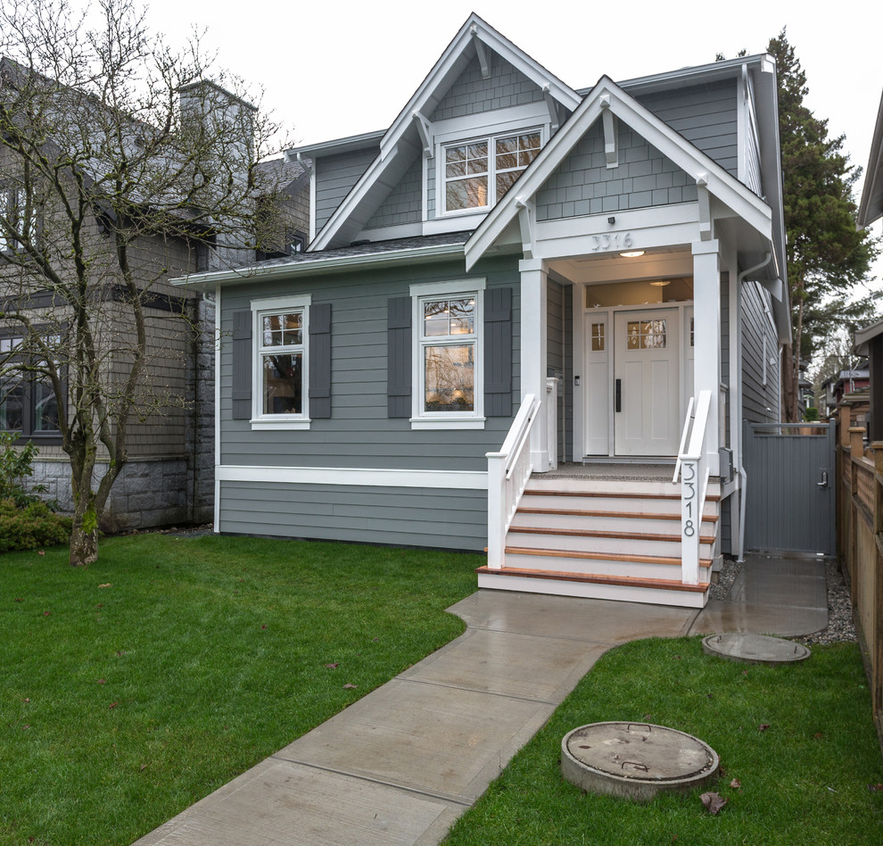 This is an example of a small and blue classic semi-detached house in Vancouver with three floors, concrete fibreboard cladding, a pitched roof and a shingle roof.
