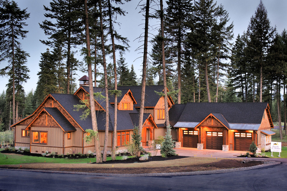 Photo of a large and brown rustic house exterior in Seattle with three floors and wood cladding.