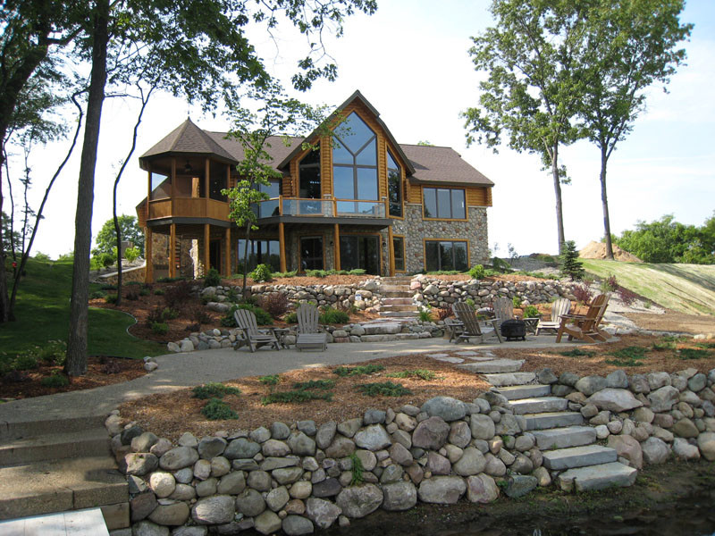 Design ideas for a large rustic two floor detached house in Grand Rapids with mixed cladding.