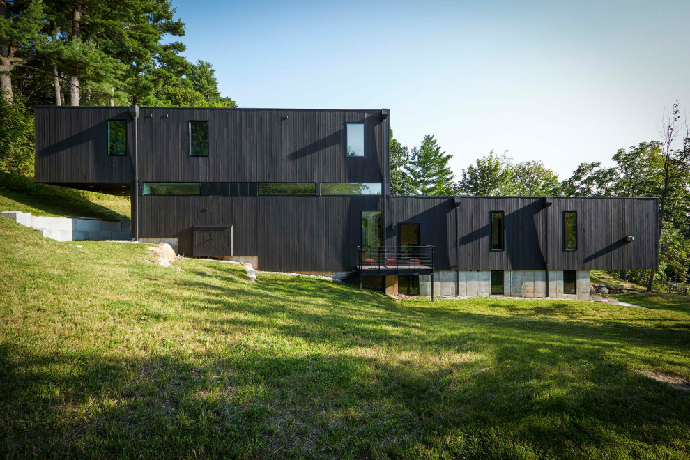 Mid-sized minimalist black two-story wood exterior home photo in Burlington