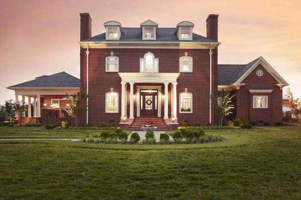 Large traditional red three-story brick house exterior idea in Chicago with a hip roof and a shingle roof
