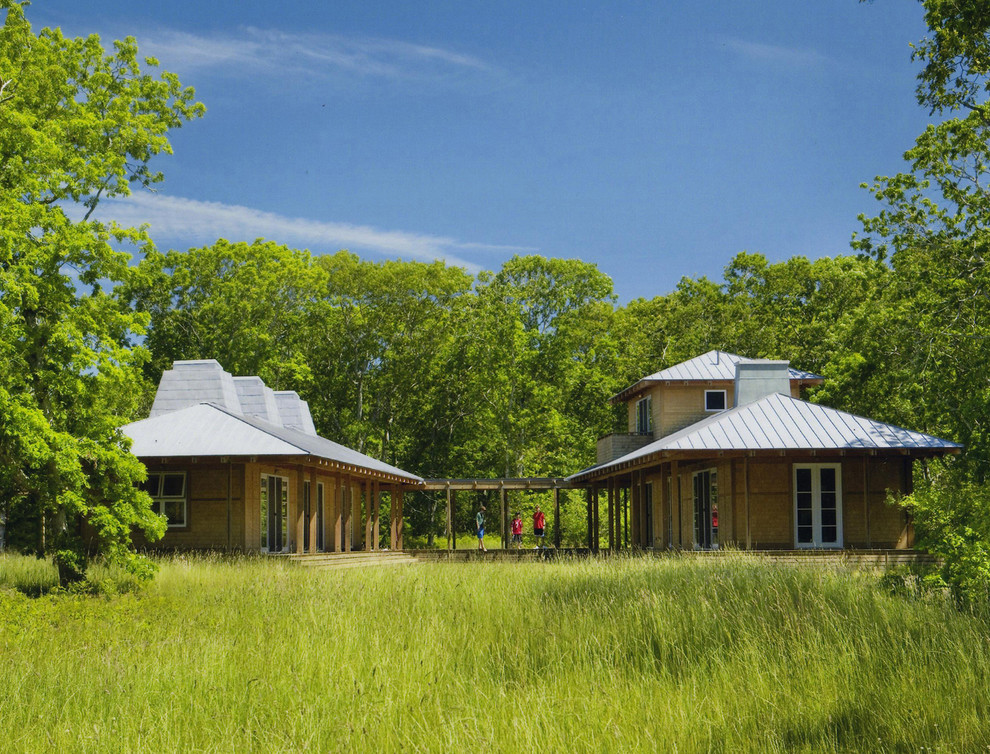 Inspiration for a rustic two floor house exterior in Boston with wood cladding.