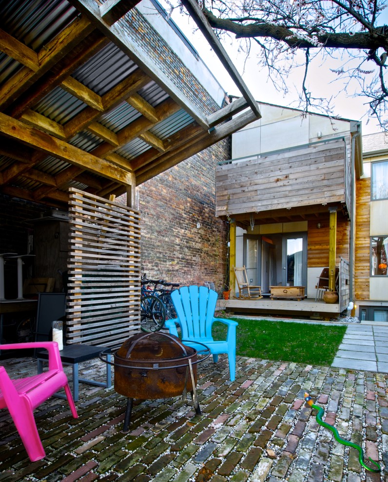 Inspiration for a contemporary house exterior in Toronto with wood cladding.