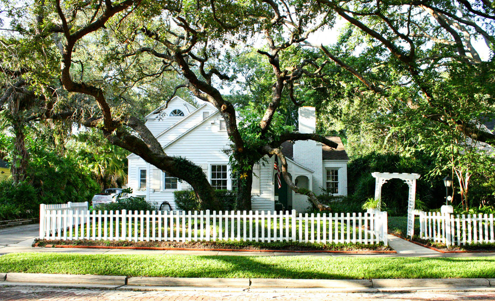 Example of a classic white two-story exterior home design in Tampa