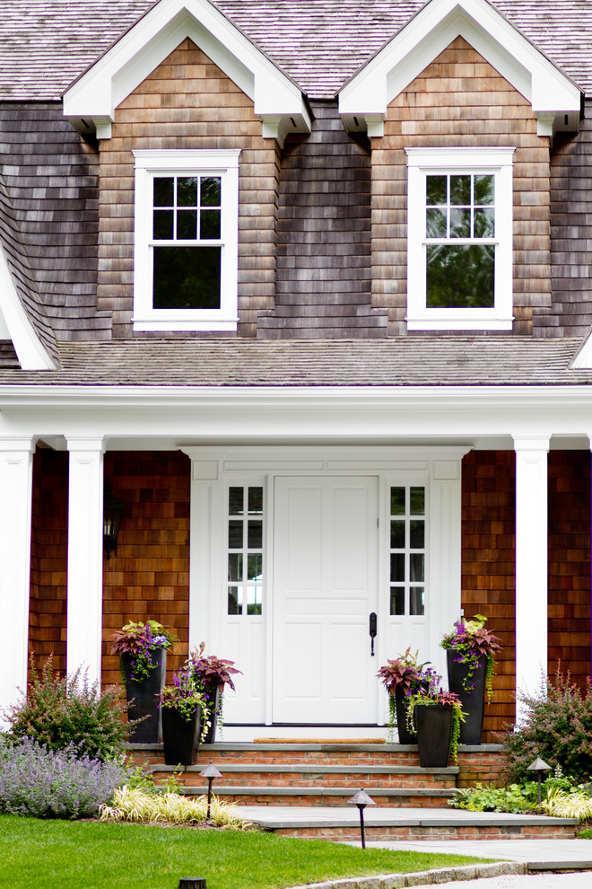 Design ideas for a traditional house exterior in New York with wood cladding.