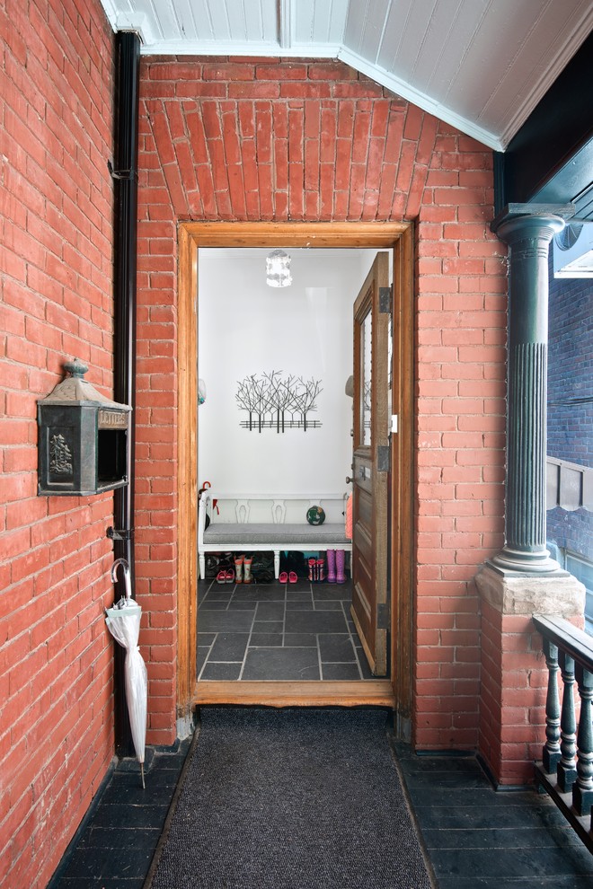 Inspiration for a small and red classic brick house exterior in Toronto.
