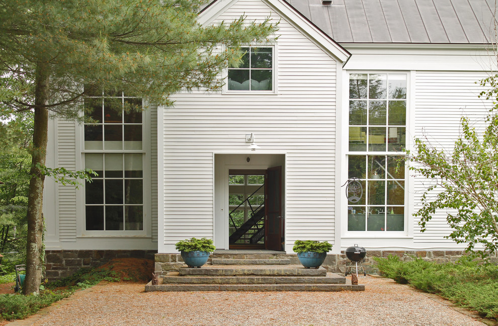 Inspiration for a white classic two floor house exterior in Burlington with wood cladding.