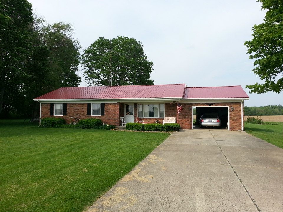 Example of a small 1950s red one-story brick gable roof design in Indianapolis