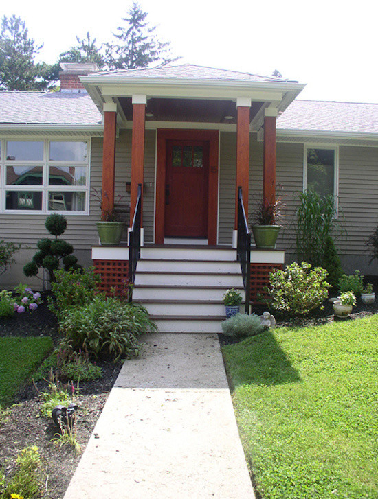 This is an example of a beige world-inspired bungalow house exterior in Boston.