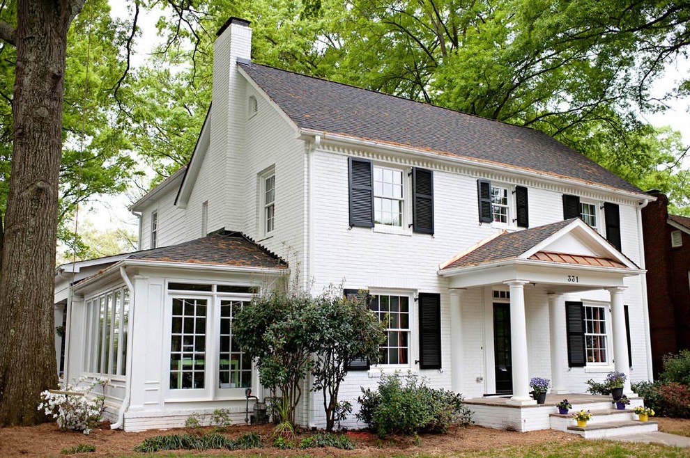 This is an example of a white country two floor house exterior in Charlotte.
