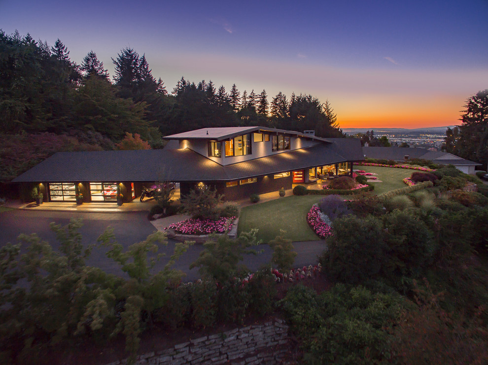 Inspiration for a large mid-century modern black two-story wood gable roof remodel in Portland