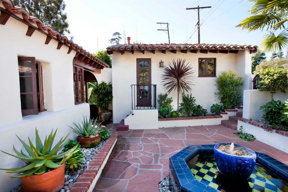 Inspiration for a mediterranean render house exterior in San Diego.