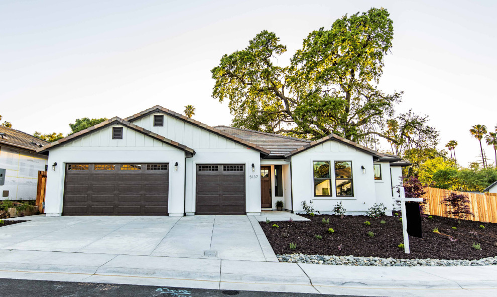 Example of a mid-sized transitional white one-story mixed siding exterior home design in Sacramento with a tile roof