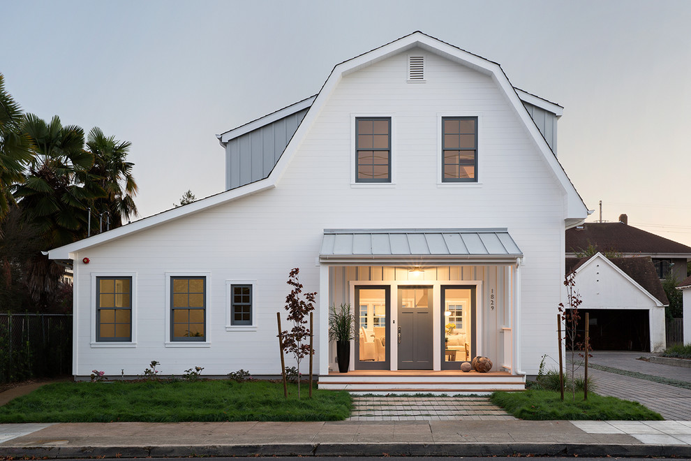 Ispirazione per la facciata di una casa bianca country a due piani di medie dimensioni con rivestimento in legno e tetto a mansarda