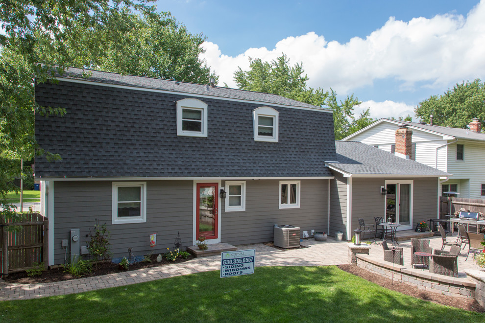 Mid-sized elegant gray two-story concrete fiberboard exterior home photo in Chicago with a gambrel roof