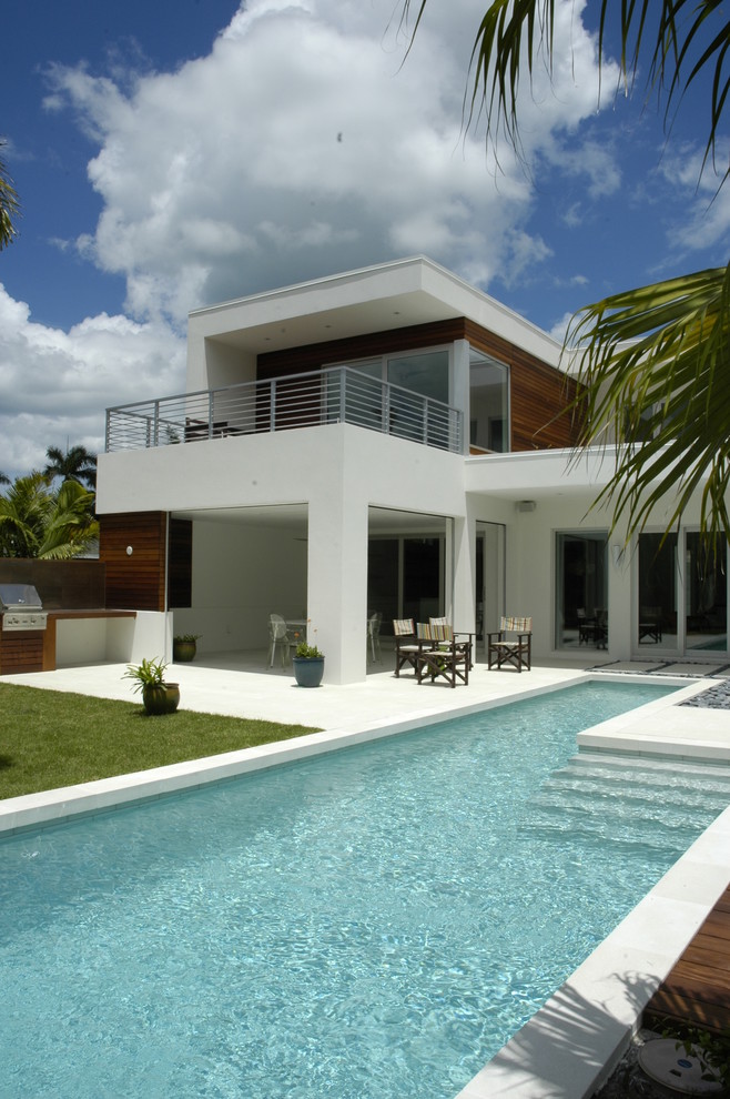 Inspiration for a mid-sized modern white two-story stucco flat roof remodel in Miami