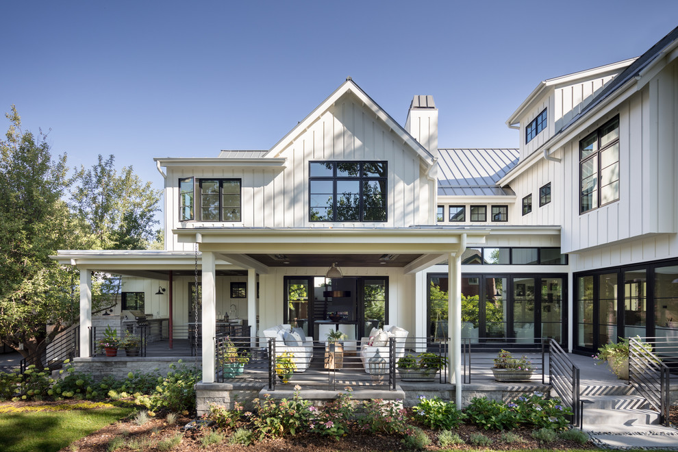 Inspiration for a country white two-story wood exterior home remodel in Denver with a metal roof