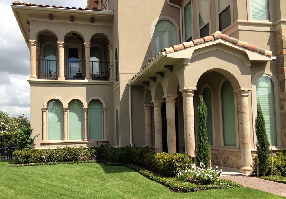 Imagen de fachada de casa beige mediterránea de tamaño medio de dos plantas con revestimiento de estuco