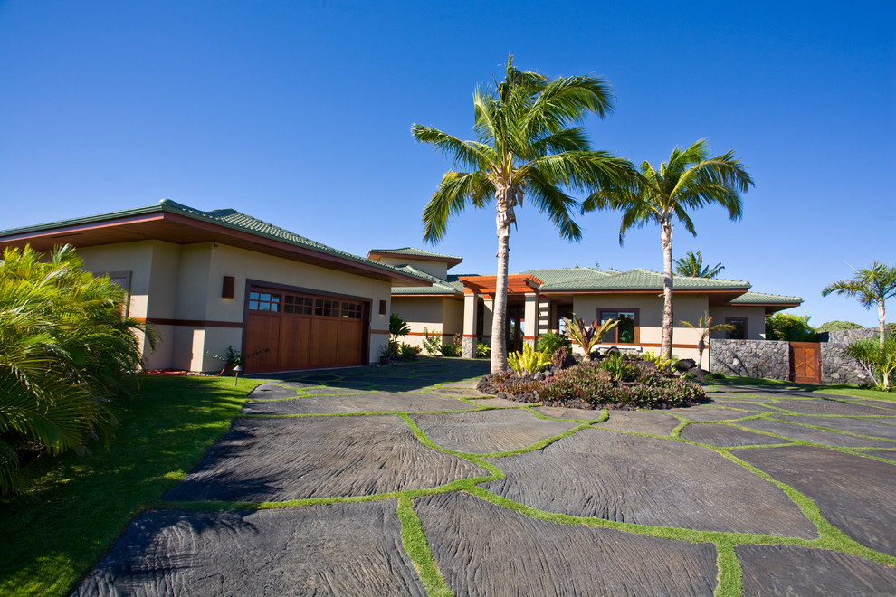 Inspiration for a huge coastal beige two-story stucco house exterior remodel in Hawaii with a hip roof and a tile roof
