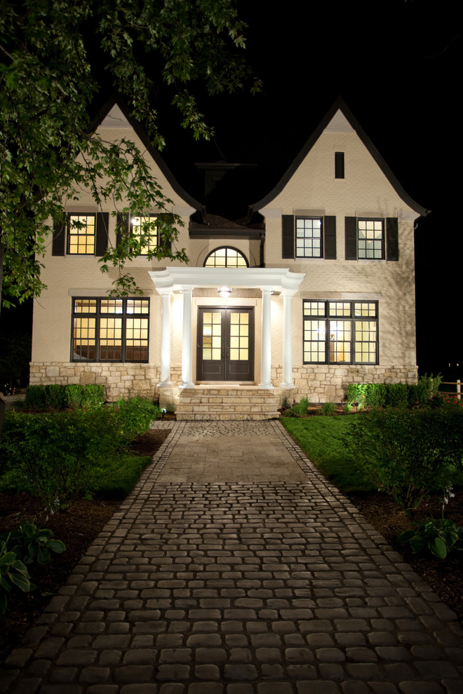 Photo of a large and beige classic two floor brick house exterior in Chicago.