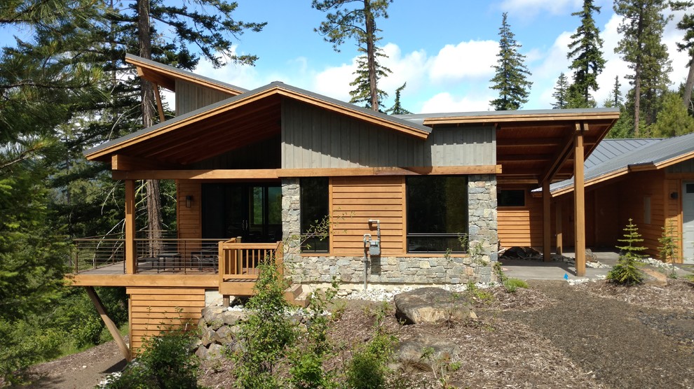 Inspiration for a large rustic blue two-story wood exterior home remodel in Seattle with a shed roof and a metal roof
