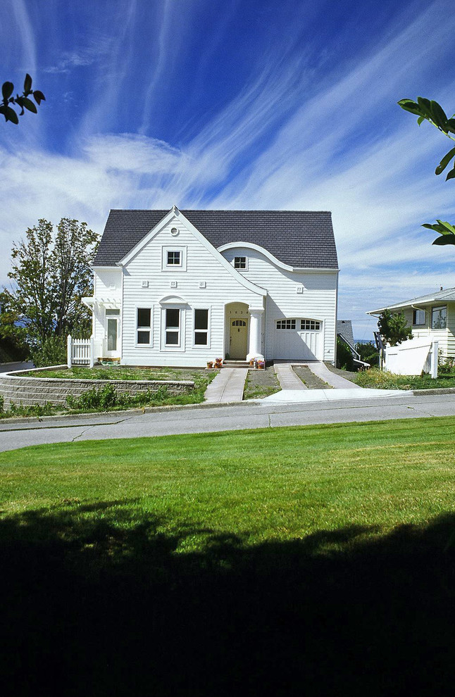 Cette photo montre une grande façade de maison blanche chic en bois à un étage avec un toit à deux pans et un toit en shingle.