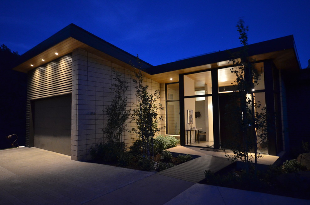 Inspiration for a beige modern two floor house exterior in Denver with mixed cladding and a lean-to roof.
