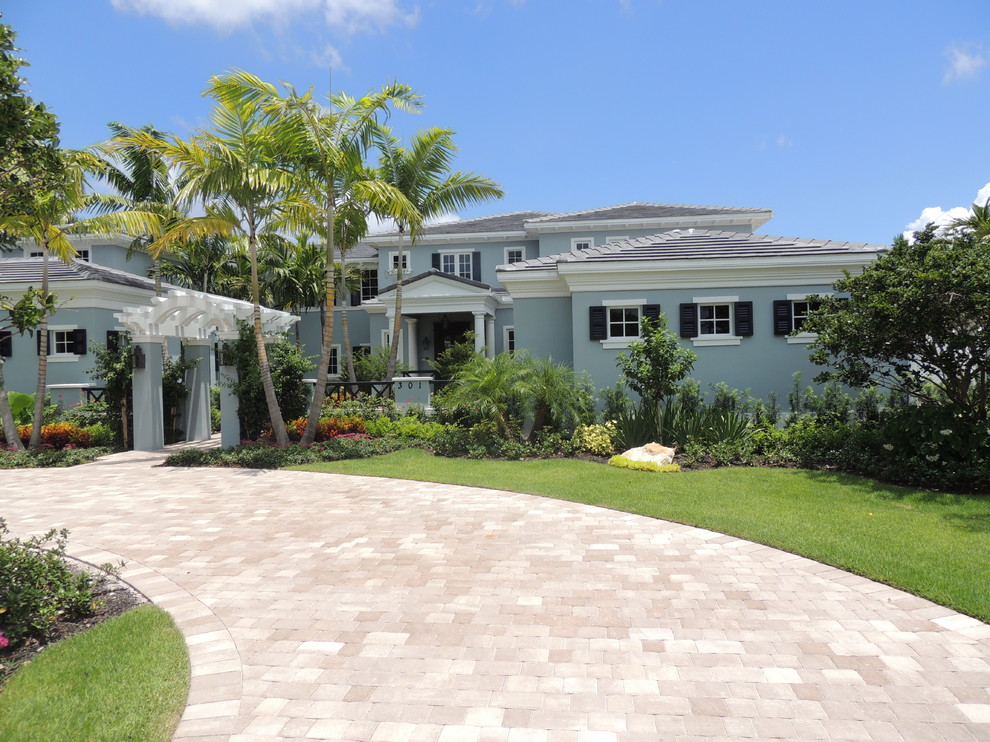 Inspiration for a large timeless blue two-story stucco exterior home remodel in Miami